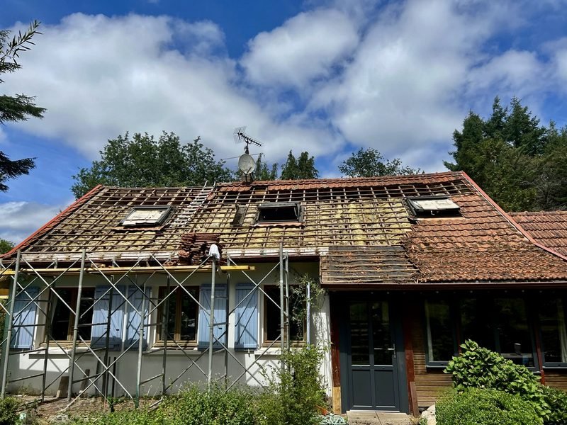 Toiture en tuiles en cours de rénovation, tuiles déposées et échafaudage